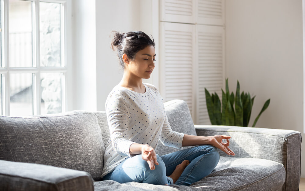 Women practicing meditation at home