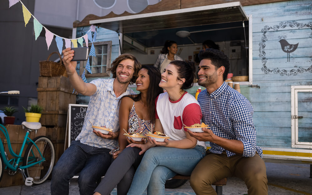 Millennials eating fermented foods from a food truck